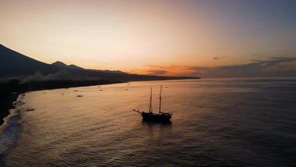 old wooden pirate boat anchored at the beach for sunset