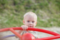 Little boy rides on carousel swing. Toddler plays on playground in summer. Concept of kindergarten - PhotoDune Item for Sale