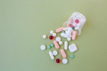 Many different pills in plastic cup on green background. Copy space. Concept of pharmaceuticals - PhotoDune Item for Sale