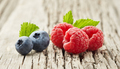 Raspberry and blueberry in closeup on wooden background - PhotoDune Item for Sale