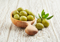Green olives with leaves on old white wooden background - PhotoDune Item for Sale