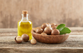 Macadamia nuts with oil on old wooden background - PhotoDune Item for Sale