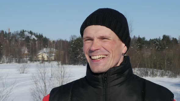 Portrait of Smiling Young Man in Winter Outdoors