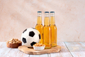 Beer and snack on wooden table with football ball, football game night food - PhotoDune Item for Sale