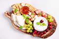 Healthy mediterranean cheese and fruits board with white wine on light background - PhotoDune Item for Sale