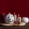 Autumn home decor for Halloween with ceramic pumpkins, burning candles. Cozy autumn home concept - PhotoDune Item for Sale