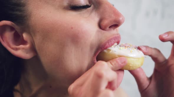 Woman Eating a Donut Closeup