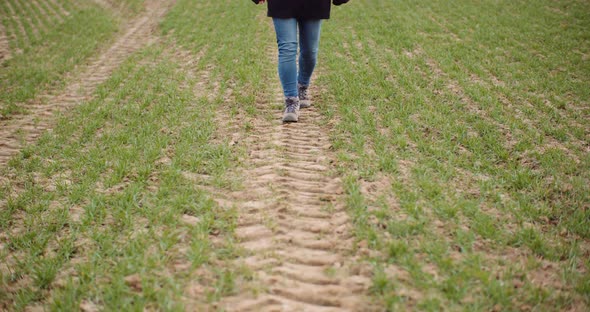 Agriculture - Female Farmer Walking on Agricultural Field