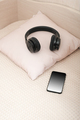 girl's bed with natural linen bedcover, smartphone and headphones, , scandinavian style bed. - PhotoDune Item for Sale
