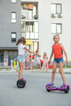 Happy children riding on hoverboards or gyro scooters outdoors in summer. Active life concept. - PhotoDune Item for Sale
