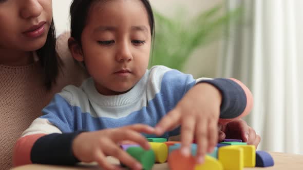 Hispanic Mother and Kid Having Fun Playing Didactic Games at Home