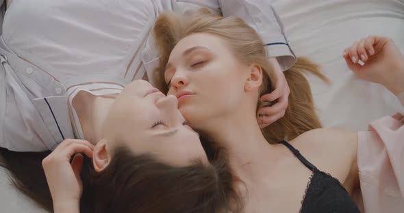 Two lesbians are kissing in bed LGBT Gay Lesbian Bisexual Transgender Lesbian concept Love