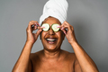 Happy African senior woman having skin care spa day - People wellness lifestyle concept - PhotoDune Item for Sale