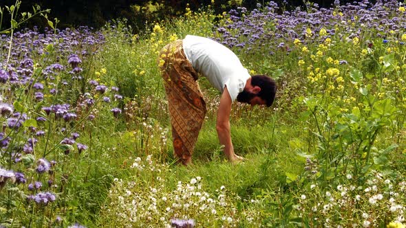 Man performing yoga on a field