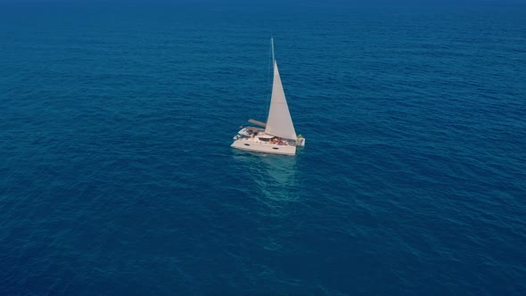 Catamaran Sailing on the Sea. Aerial Shoot of the Catamaran Sailing in the Wind.