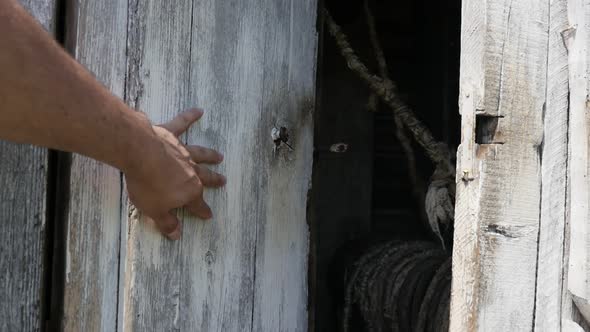 Water well house doors closing with hand slow-mo footage