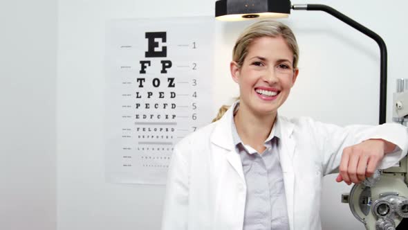 Beautiful optometrist standing in ophthalmology clinic