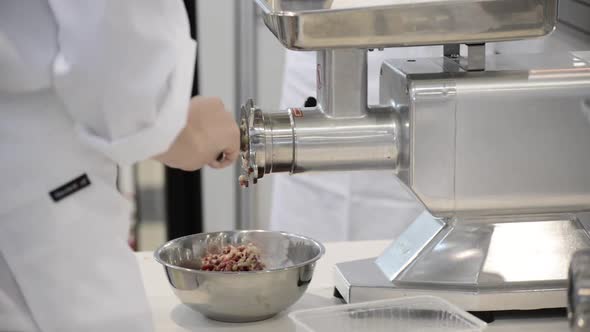 The Cook Cleans the Meat Grinder From Minced Meat