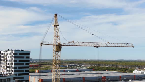 Tower Crane Stands on Construction Site of Residential Area