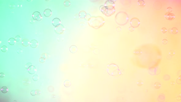 Blue and Clear Soap Bubbles on Turquoise and Pink, Background