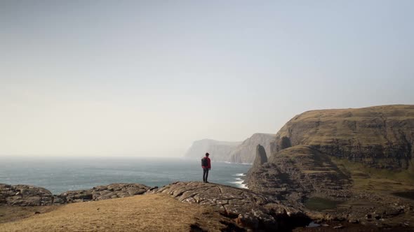 Man Overlooking Sea And Dramatic Landscape