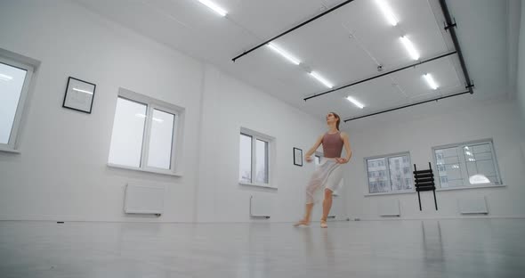 Ballerina in Pointe Shoes Runs Through the Dance Room and Jumps Several Times in Slow Motion Dance