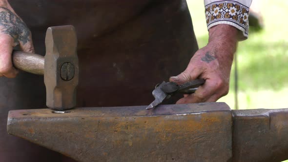 blacksmith creating sharp weapon slow motion hammering 4k