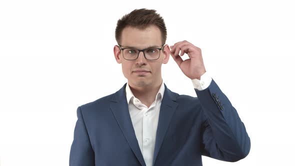 Handsome Businessman in Blue Suit Looking Confused Takingoff Glasses and Being Surprised with