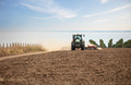 Farmer in tractor working in field on summer day - PhotoDune Item for Sale