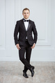 Attractive young man standing in tuxedo and looking at camera - PhotoDune Item for Sale