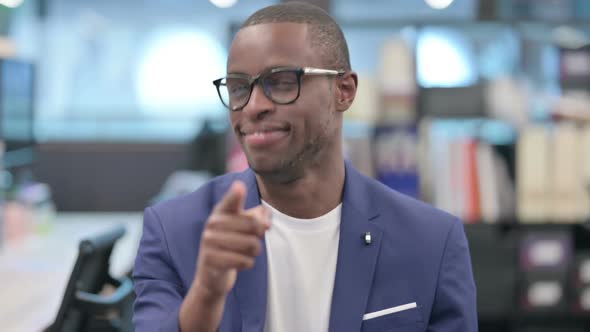 Portrait of African Businessman Pointing at Camera Inviting