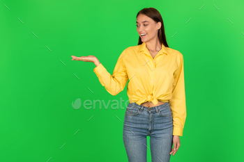 anding Over Green Studio Background. Lady Advertising Product. Look At This, Advertisement Banner Concept