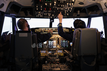 Captain and woman copilot getting ready to fly airplane