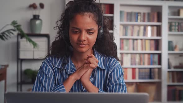 Young Indian Woman in Wired Headset is Nervous During Work Sits in Office