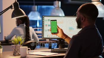 reen in business office. Analyzing blank mockup template with chroma key copyspace and isolated background display on telephone.