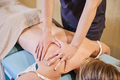 Professional female physiotherapist giving shoulder massage to a woman - PhotoDune Item for Sale