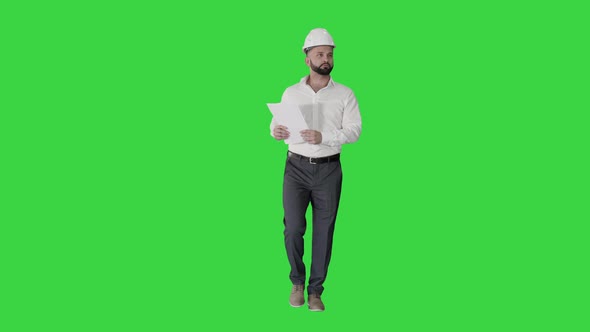 Male Site Contractor Engineer Hard Hat Walking Looking Object Into Papers Documents Green Screen