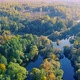 Aerial View of the River Among Forest in the Wild During Fall Season at Sunset - VideoHive Item for Sale