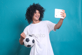 ng football sport team while holding mobile phone to watch soccer ball tv live stream