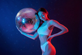 Party time. Holding mirrored ball. Young woman in underwear is in the studio with neon lights - PhotoDune Item for Sale