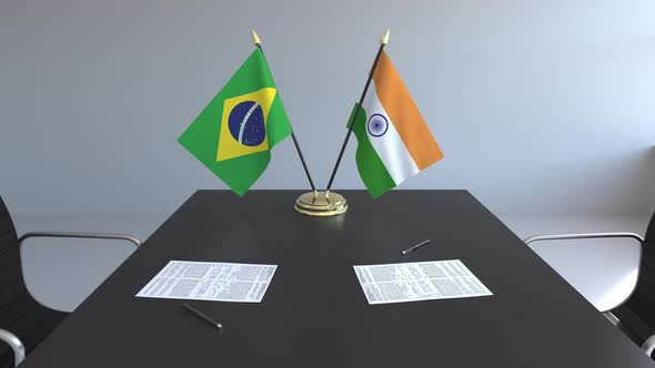 Flags of Brazil and India on the Table