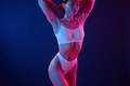 Fitness type body. Young woman in underwear is in the studio with neon lights - PhotoDune Item for Sale