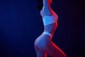 Fitness type body. Young woman in underwear is in the studio with neon lights - PhotoDune Item for Sale