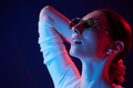 Wearing glasses. Portrait of young woman that is indoors in neon lighting - PhotoDune Item for Sale
