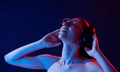 Feel the music. In headphones. Portrait of young woman that is indoors in neon lighting - PhotoDune Item for Sale