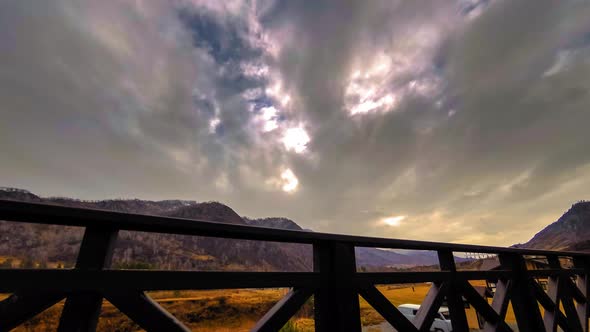 Timelapse of Wooden Fence on High Terrace at Mountain Landscape with Clouds