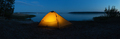 Orange illuminated tourist tent on lake in evening - PhotoDune Item for Sale