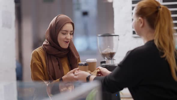 Portrait of Happy Muslim Young Woman Receiving Takeaway Coffee in Cafeteria and Leaving