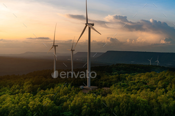 ergy. Wind turbines generate electricity. Windmill farm on a mountain with sunset sky. Green technology. Renewable resource. Sustainable development.