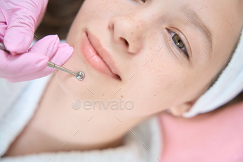 chin of cute girl in beauty salon. Cropped face photo